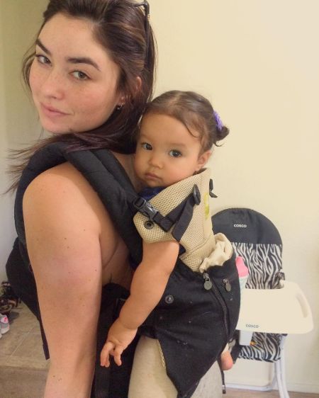 Molly Noriko Hurley carries her baby girl Kimiko Flynn on her back.